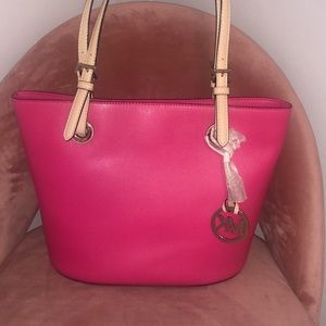 A hot pink Michael Kors handbag